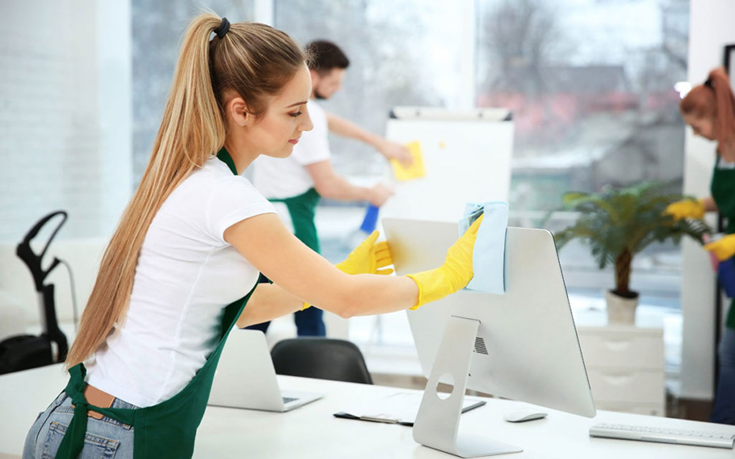 Woman cleaning computer screen