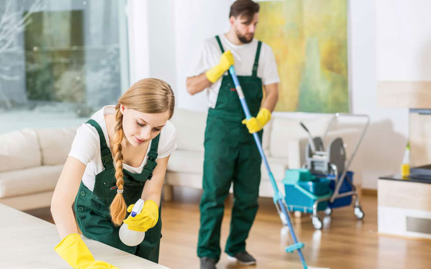 Two people cleaning living room